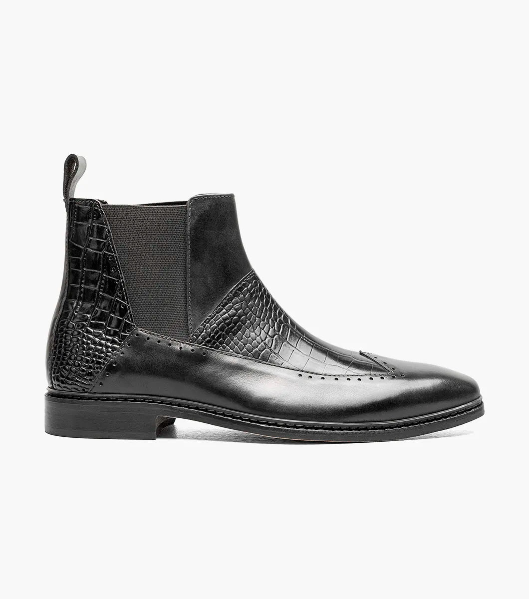 The Stacy Adams Garza Wingtip Chelsea Boot (Black, 25782-001) features crocodile texture accents, elastic side panels, a heel pull tab, and a low heel on a flat sole.