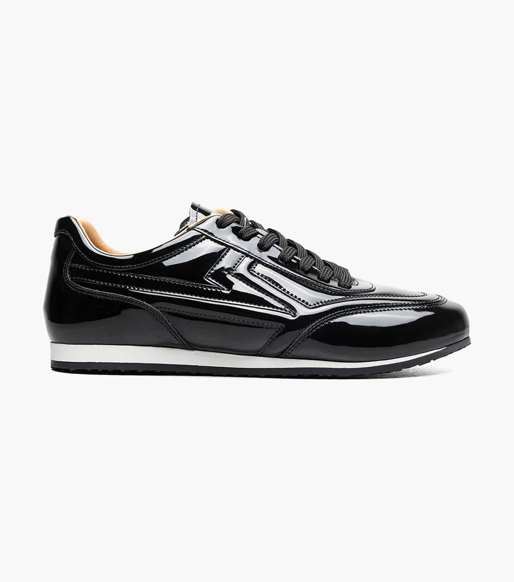 The STACY ADAMS Action 150 Sporty Lace Up in Black Patent (25797-004) features black laces, a white sole, and decorative stitching—presented on a white background for a sleek modern update to men’s casual footwear with a sporty lace-up design.