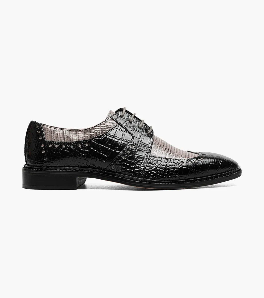 The Stacy Adams Travato Wingtip Oxford (Style 25737-975) in Black and Gray is a dress shoe expertly crafted from croco print leather, showcasing a distinctive crocodile and lizard pattern. This STACY ADAMS oxford features a lace-up design, low heel, and anatomical arch support, presented against a white background.