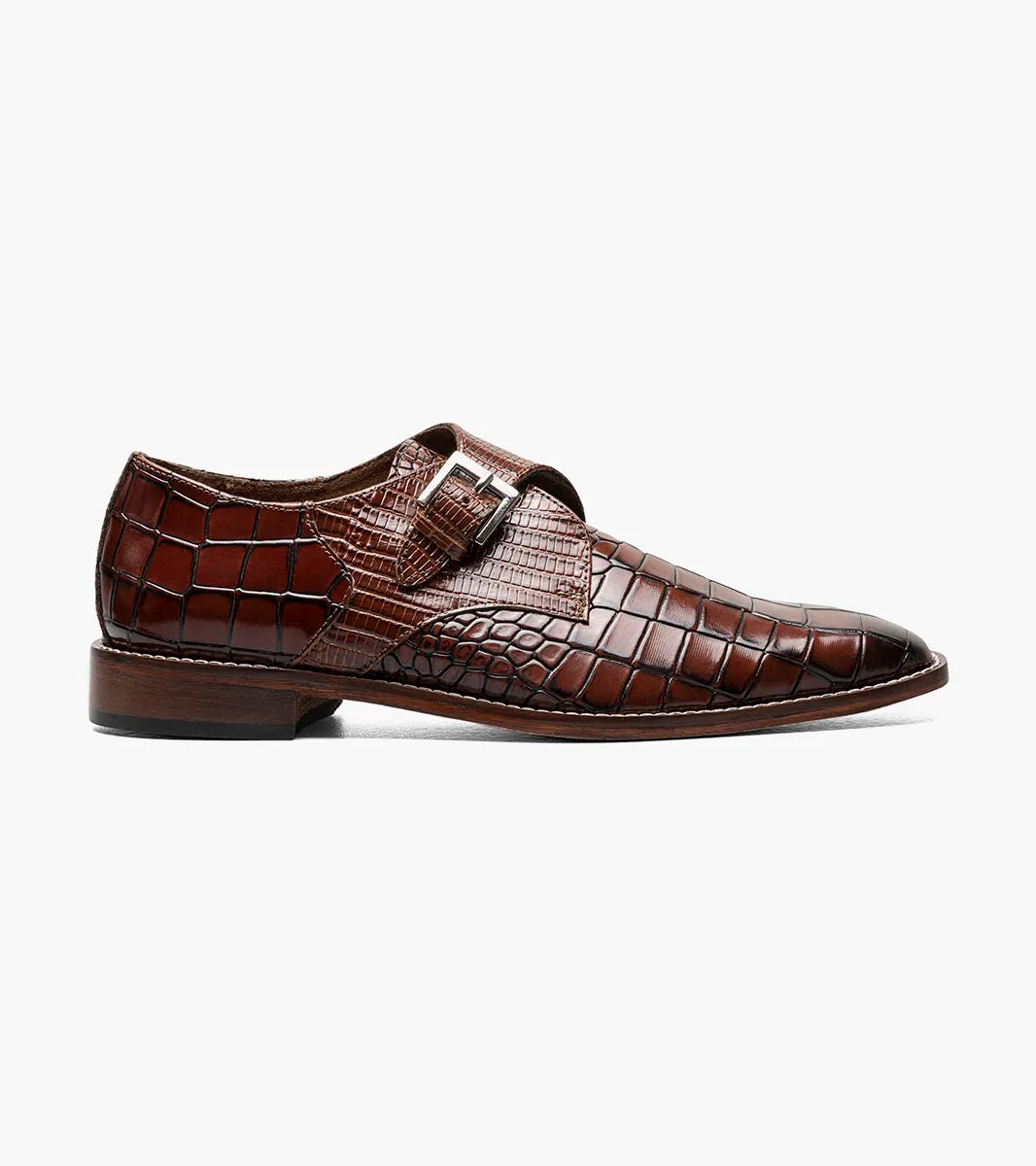 The STACY ADAMS Rapino Plain Toe Monk Strap in cognac (25637-221) features a brown crocodile print leather, side buckle closure, and low heel, shown on a white background.