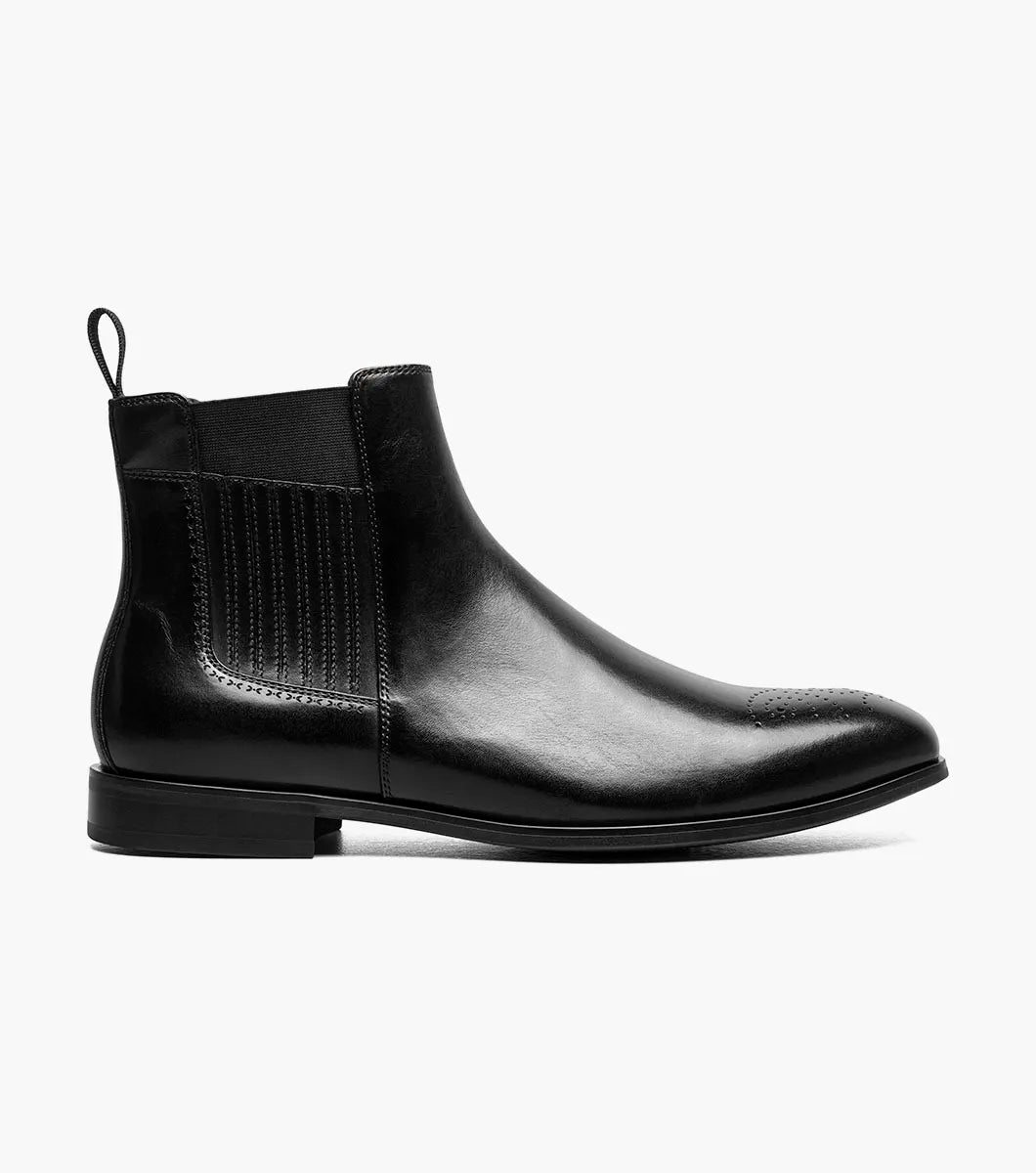 The Stacy Adams Bradley Plain Toe Chelsea Boot in black (25677-001) by STACY ADAMS features a molded heel cup, FLEXZONE branding, anatomical arch support, a cushioned heel pod, and plush Memory Foam footbed against a dark background.