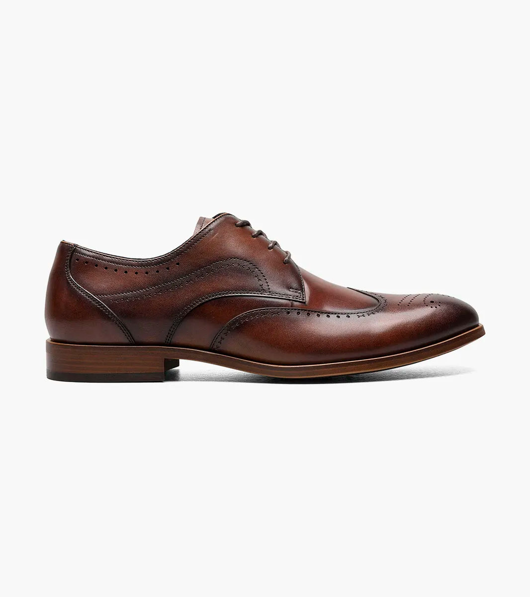 The STACY ADAMS Brayden Wingtip Oxford in brown (25635-200) features burnished leather, decorative perforations, laces, and a low wooden heel, shown on a white background.