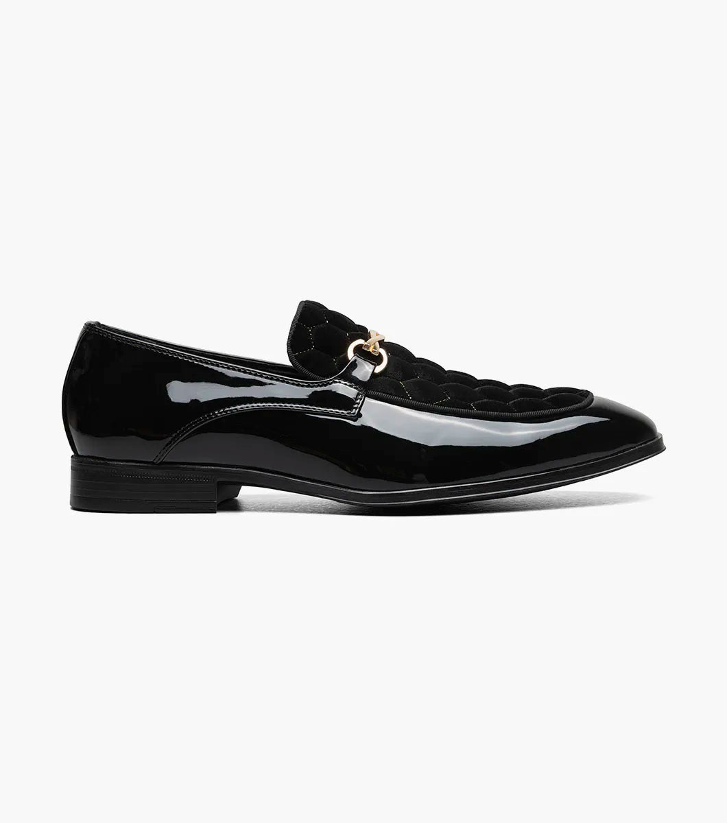 The STACY ADAMS Sprague Moc Toe Bit Slip On (Black, 25732-001) features a textured patent leather upper, gold metal bit detail, and low heel—ideal for elevating your dress shoe collection.