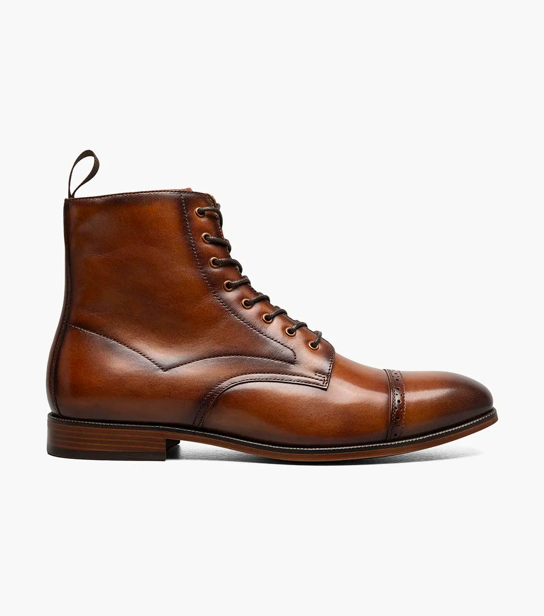 The Stacy Adams Henry Cap Toe Lace Up Boot in tan (style 25718-240) features a leather upper, decorative stitching, cap toe, low heel, and anatomical arch support. Shown in side profile against a white background.