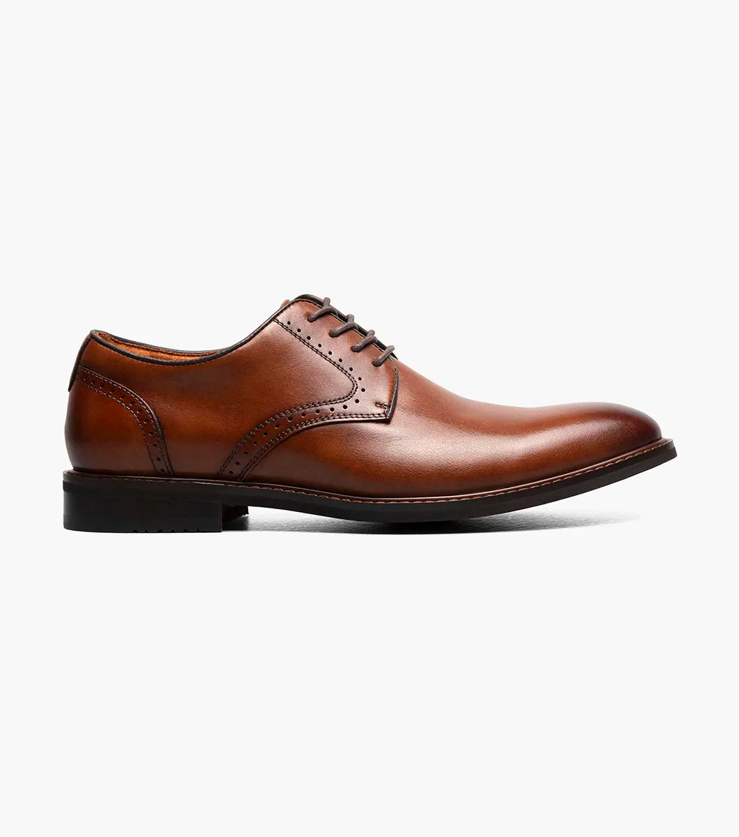The Stacy Adams Benson Plain Toe Oxford in Brandy (25751-226) is a brown lace-up dress shoe made from hand-burnished leather, with a low heel and polished finish, shown on a white background.