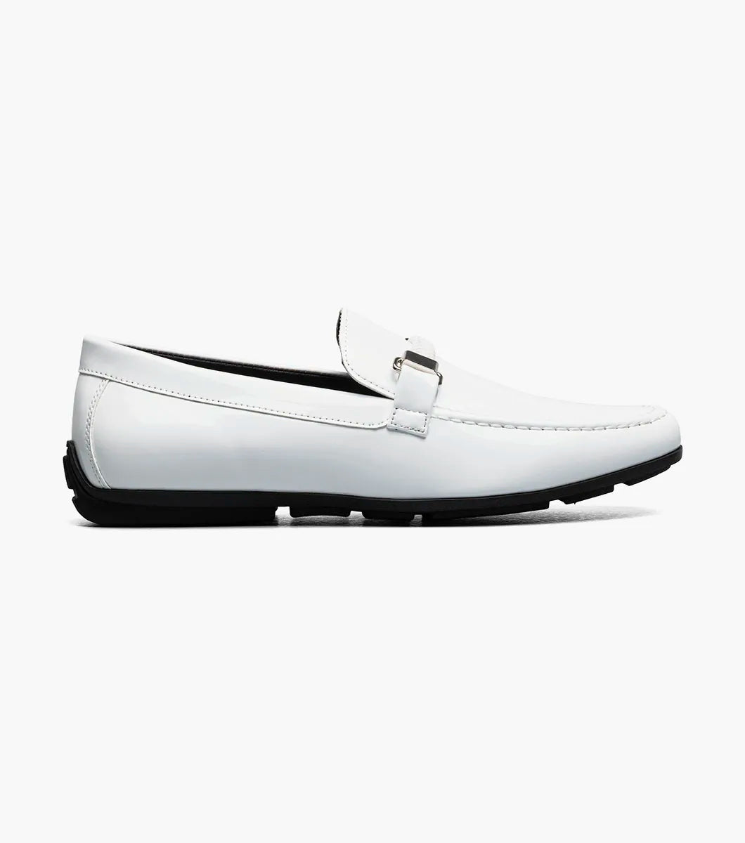The STACY ADAMS Sheridan Moc Toe Bit Slip On (25761-122) is a white patent loafer with metal bit detail, a black sole, and visible stitching, shown on a plain white background.