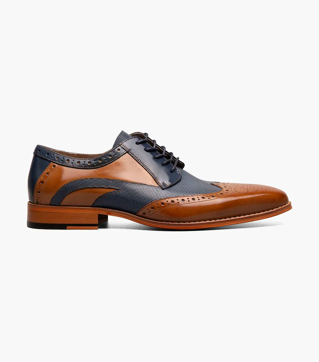 The Stacy Adams Ivingale Wingtip Oxford (Tan Multi) features brown leather and navy panels, brogue details, laces, a memory foam footbed, and a brown sole. Model: 25684-238.