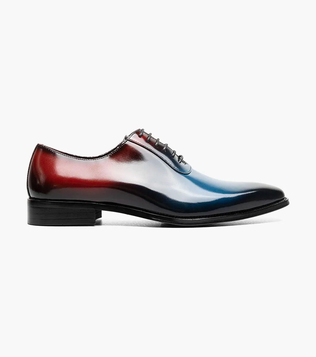 The STACY ADAMS Shaffer Plain Toe Oxford (Navy Multi, 25763-492) features premium calf leather with a gradient from deep red heel to blue toe, dark laces, and a black sole.