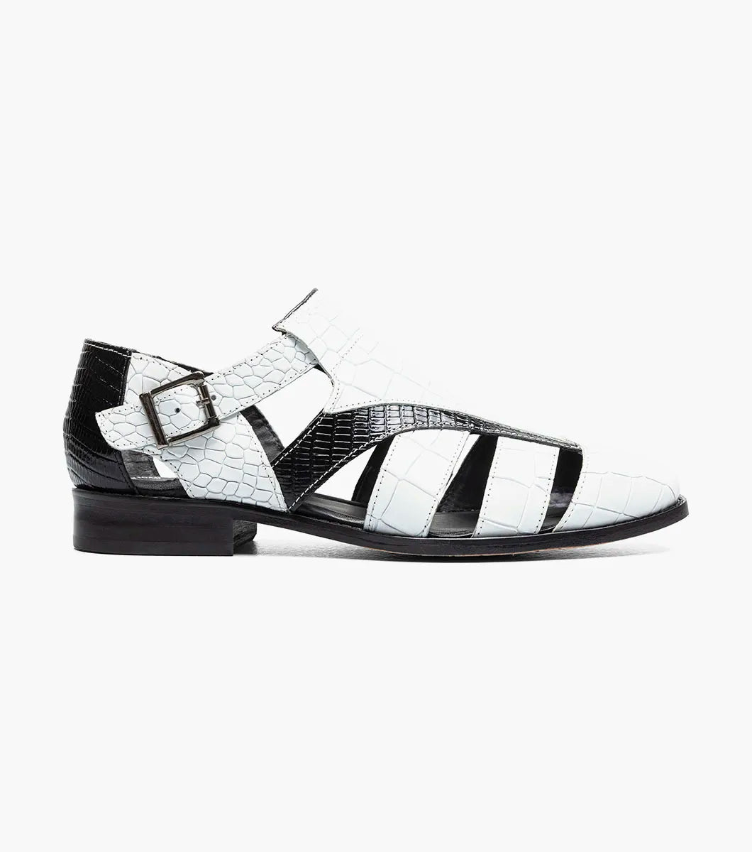 The Stacy Adams Calandro City Sandal (25695-111) features a black and white closed-toe design with cut-out sections, buckle strap, low heel, textured crocodile print leather, and a genuine leather sole.