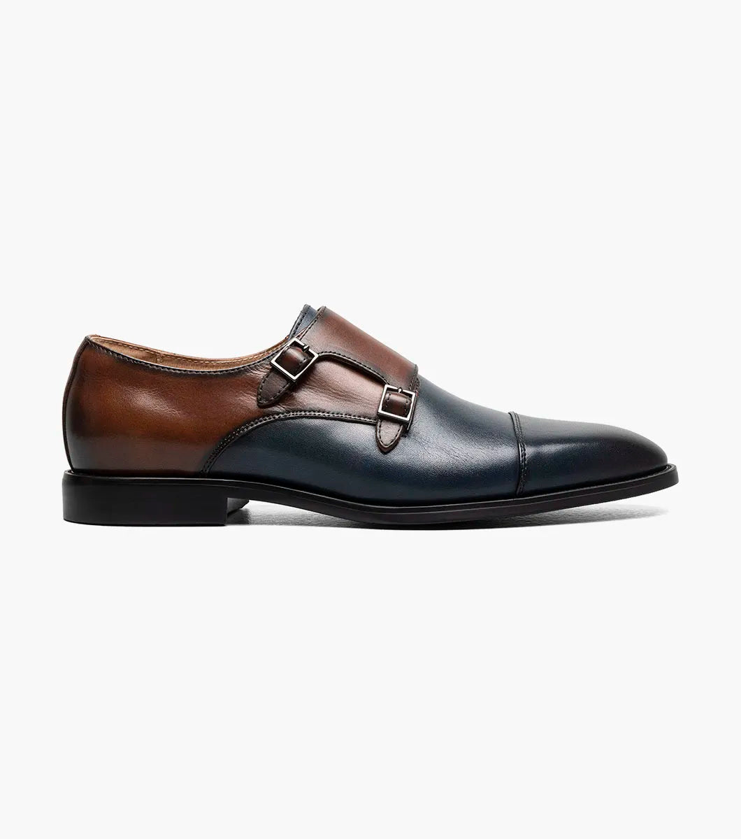 The STACY ADAMS Raythorne Cap Toe Double Monk Strap (Navy/Brown, 25671-414) is a men's leather dress shoe featuring a blue and brown upper, double monk buckles, a low black heel, and a rounded toe.
