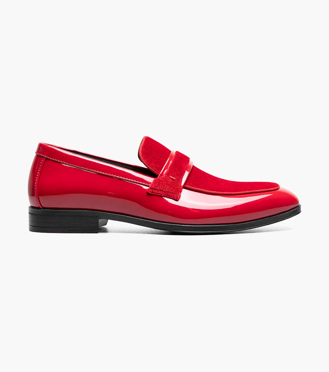The Stacy Adams Spratley Moc Toe Saddle Slip On in red features a velour upper, matte strap, and black sole. This single shiny loafer (25686-600) by STACY ADAMS is displayed on a white background.