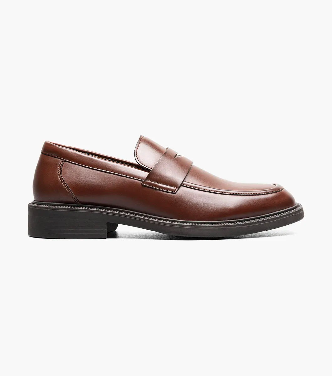 The STACY ADAMS Everett Moc Toe Penny Slip On in brown (style 25790-200) features a classic moc toe design with stitching details, a low heel, a rounded toe, and cushioned comfort from its memory foam insole, shown here against a plain white background.