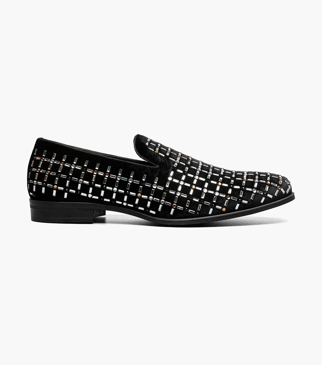 The Stacy Adams Stallford Rhinestone Slip On in Black Multi features a low heel, silver and gold grid-patterned studs, and anatomical arch support, blending dressy style with casual comfort.