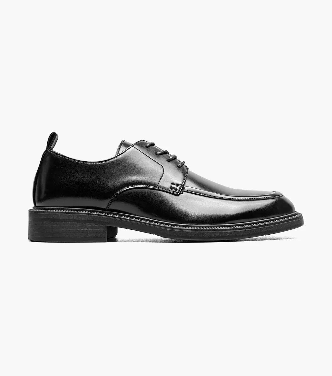 The STACY ADAMS Evan Moc Toe Oxford (Black, 25789-001) is shown as a single men’s dress shoe with a black leather upper, lace-up closure, low heel, and smooth polished finish on a plain white background. Designed for both style and comfort, it features a supportive Memory Foam footbed.