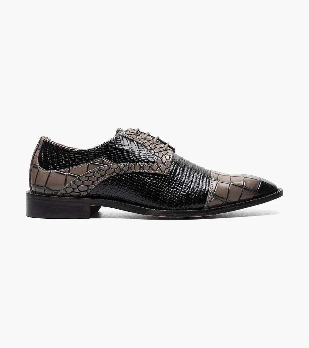 The STACY ADAMS Tedesco Cap Toe Oxford (25630-975) is a black and gray men’s dress shoe with a textured crocodile print leather and a pointed toe, offering refined sophistication.