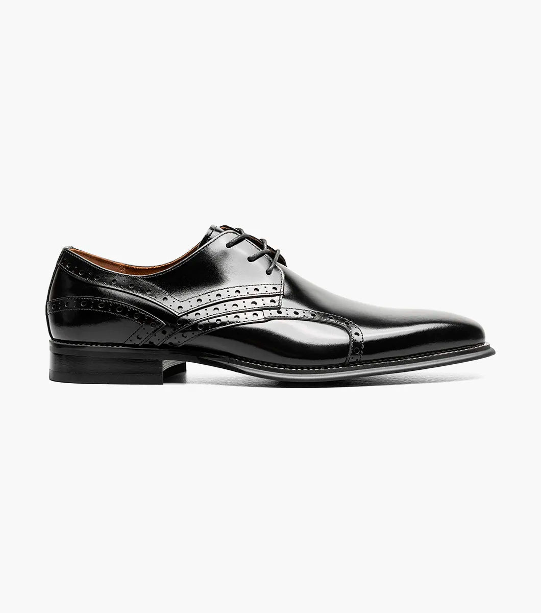 The STACY ADAMS Alexander Plain Toe Oxford in black (style 25791-001) is an elegant calf leather dress shoe with laces, decorative perforations, a low heel, and a comfortable memory foam insole, displayed on a light background.