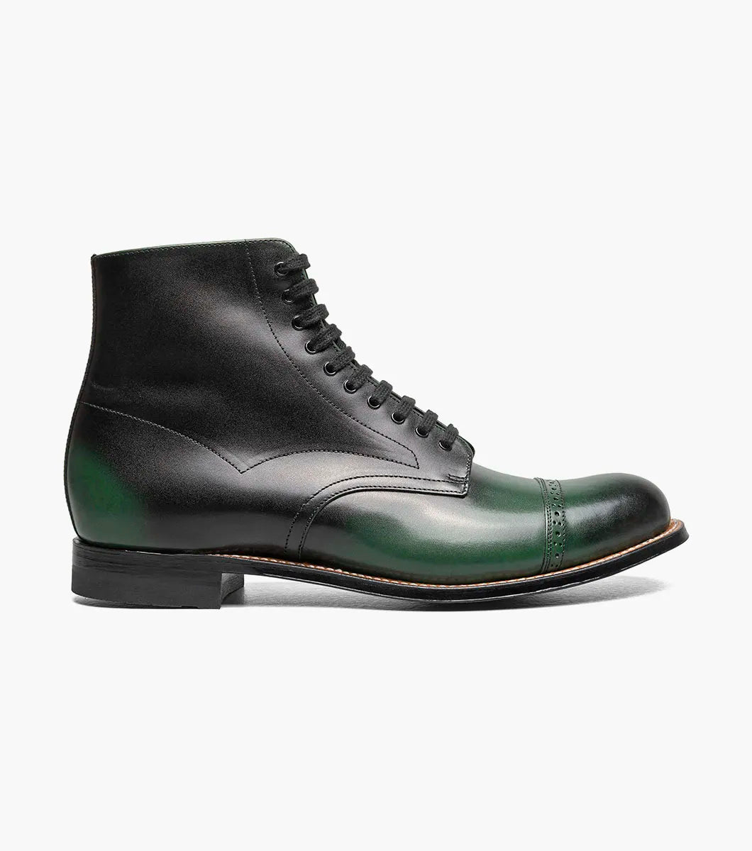 The Stacy Adams Madison Cap Toe Lace Up Boot (00110-300) features a dark green leather upper, black sole, brown welt, and closed lacing—an elegant STACY ADAMS dress boot shown on a white background.