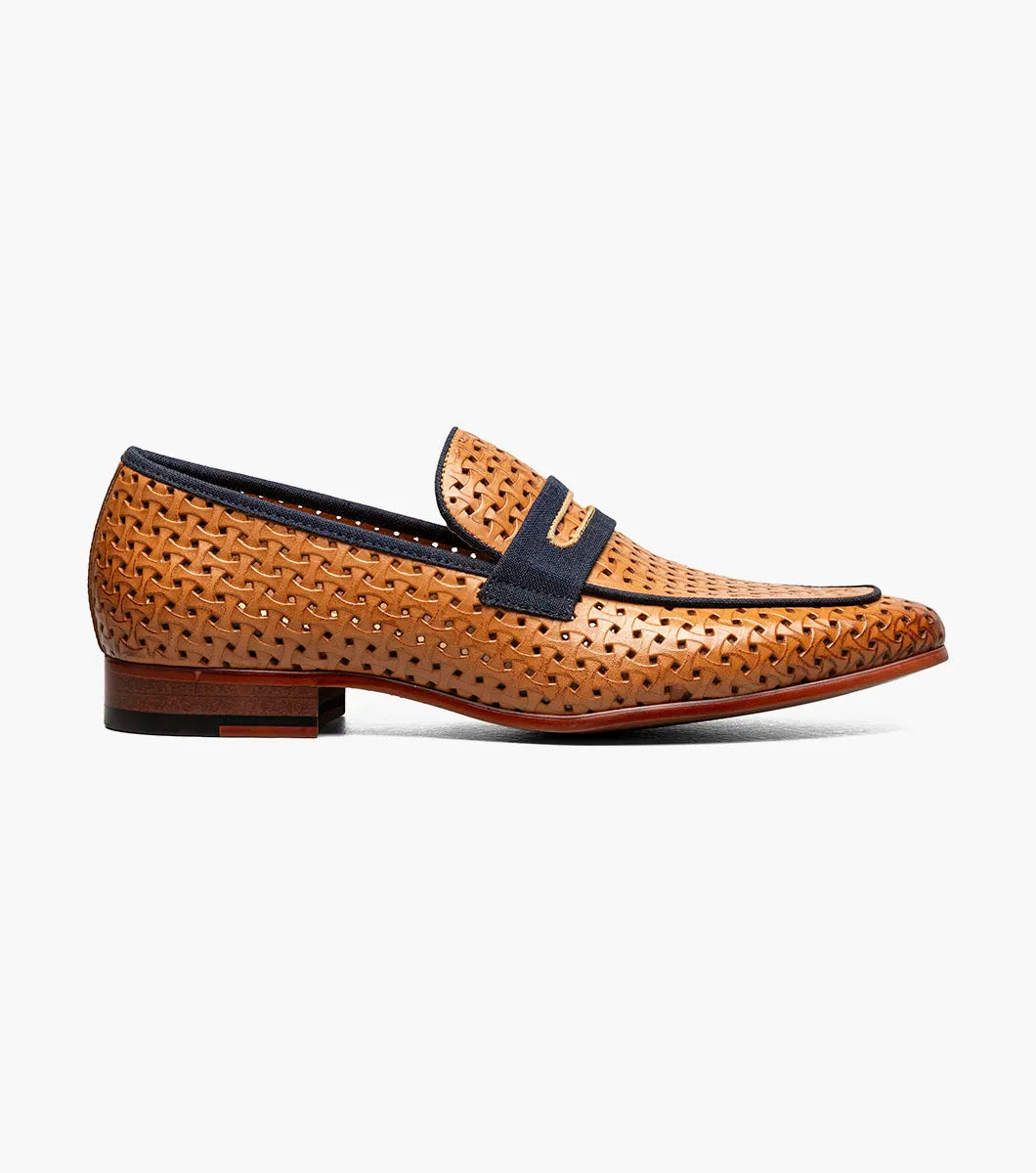 The STACY ADAMS Winstead Moc Toe Saddle Slip On in Natural features a brown woven leather upper, dark blue trim, Memory Foam insole, and low heel, displayed on a white background.