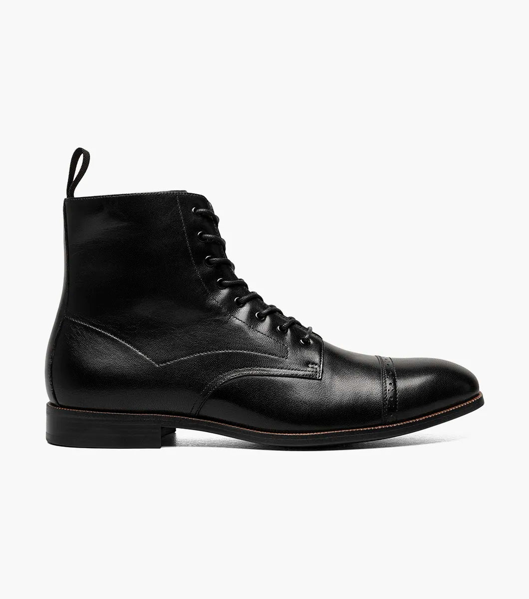 The STACY ADAMS Henry Cap Toe Lace Up Boot in black (25718-001) features leather construction, cap toe, side stitching, heel pull tab, low heel, and EVA sole—shown in side profile against a white background.