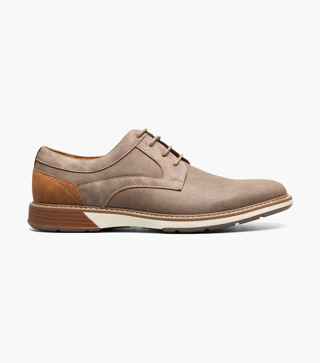 The Stacy Adams Phineas Plain Toe Oxford in taupe features a leather and fabric upper, cushioned insole, white midsole, and brown heel and sole accents. Shown in side profile on a white background.
