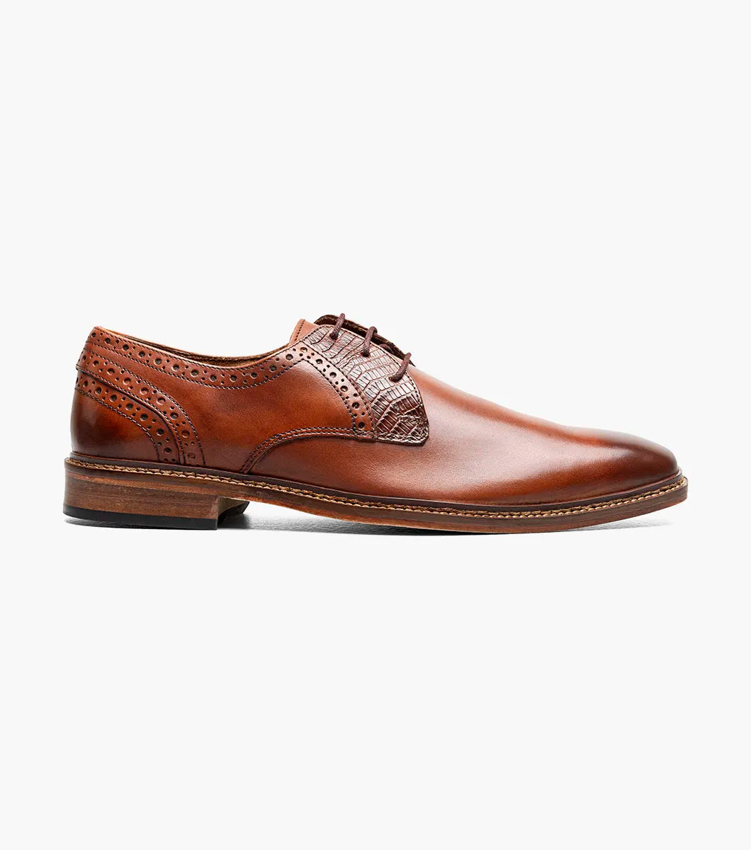 The Stacy Adams Giorgetti Plain Toe Oxford in Cognac features lizard print leather, brogue details, textured accents, a cushioned footbed, low heel, and lace-up closure.
