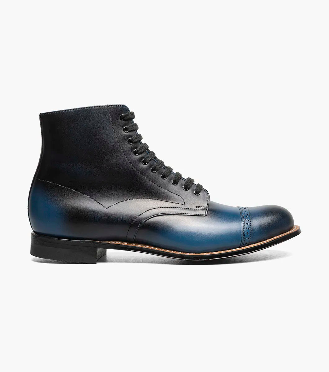 The STACY ADAMS Madison Cap Toe Lace Up Boot in blue (00110-400) is a leather dress boot with a cap toe and brogue detailing, displayed on a white background.