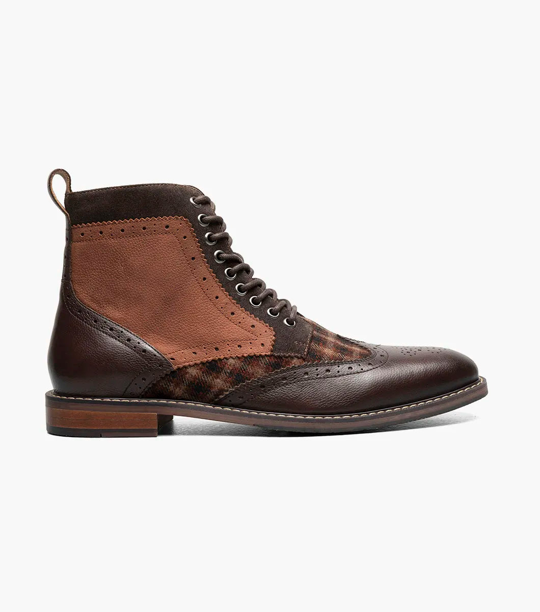 The STACY ADAMS Finnegan Wingtip Lace Up Boot in Brown Multi features leather and suede, perforated details, a patterned fabric panel, low wooden heel, and cushioned memory foam insole for comfort. Style #: 25427-249.