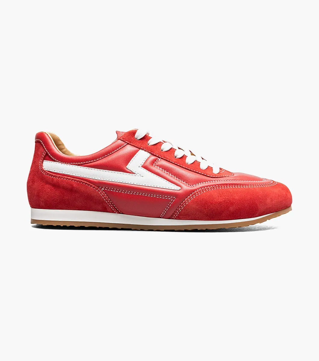 Introducing the STACY ADAMS Action 150 Sporty Lace Up in red (style 25797-600), a modern sneaker highlighted by sporty white laces and a distinctive white zigzag pattern along the side, displayed against a plain white background. The cushioned footbed provides comfort with every step.