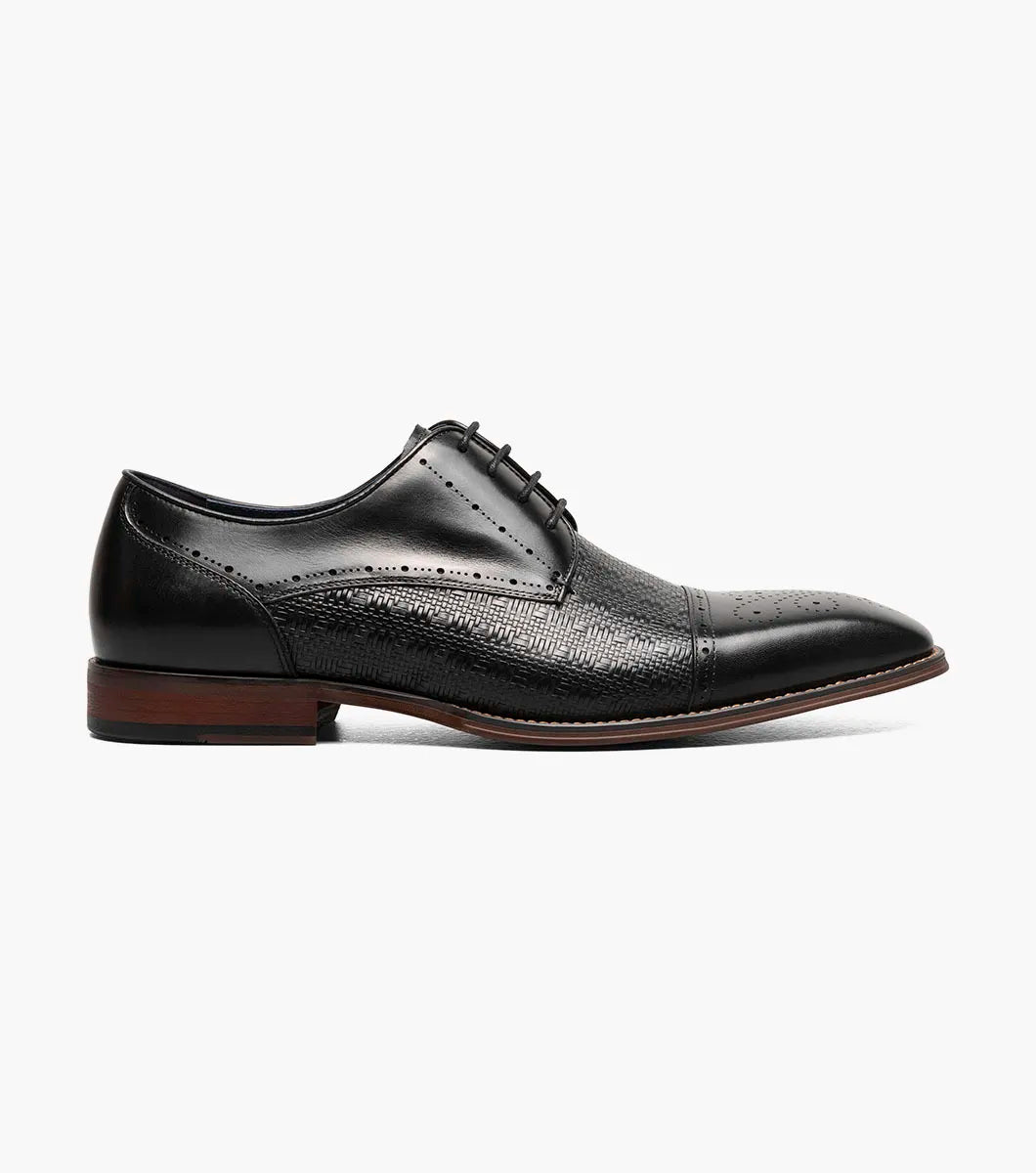 The Stacy Adams Silsbury Cap Toe Oxford in black features a leather upper with textured pattern, wooden heel, elegant perforated detailing, and a Memory Foam footbed for comfort. Style code: 25675-001.