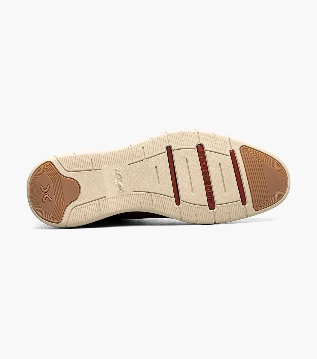 The Stacy Adams Eastmont Plain Toe Elastic Lace Chukka Boot in cognac features a perforated design, light tan rubber sole, and anatomical arch support for all-day comfort, shown on a white background.