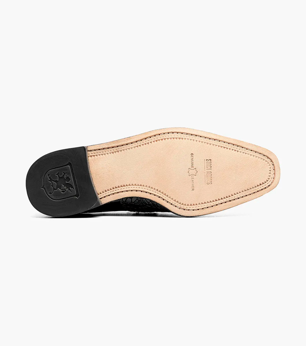 The Stacy Adams Rubiano Moc Toe Buckle Strap Slip On in brown (style 25787-200) by STACY ADAMS is a single leather loafer featuring a crocodile print, slip-on design, side buckle detail, and low heel, displayed on a white background.