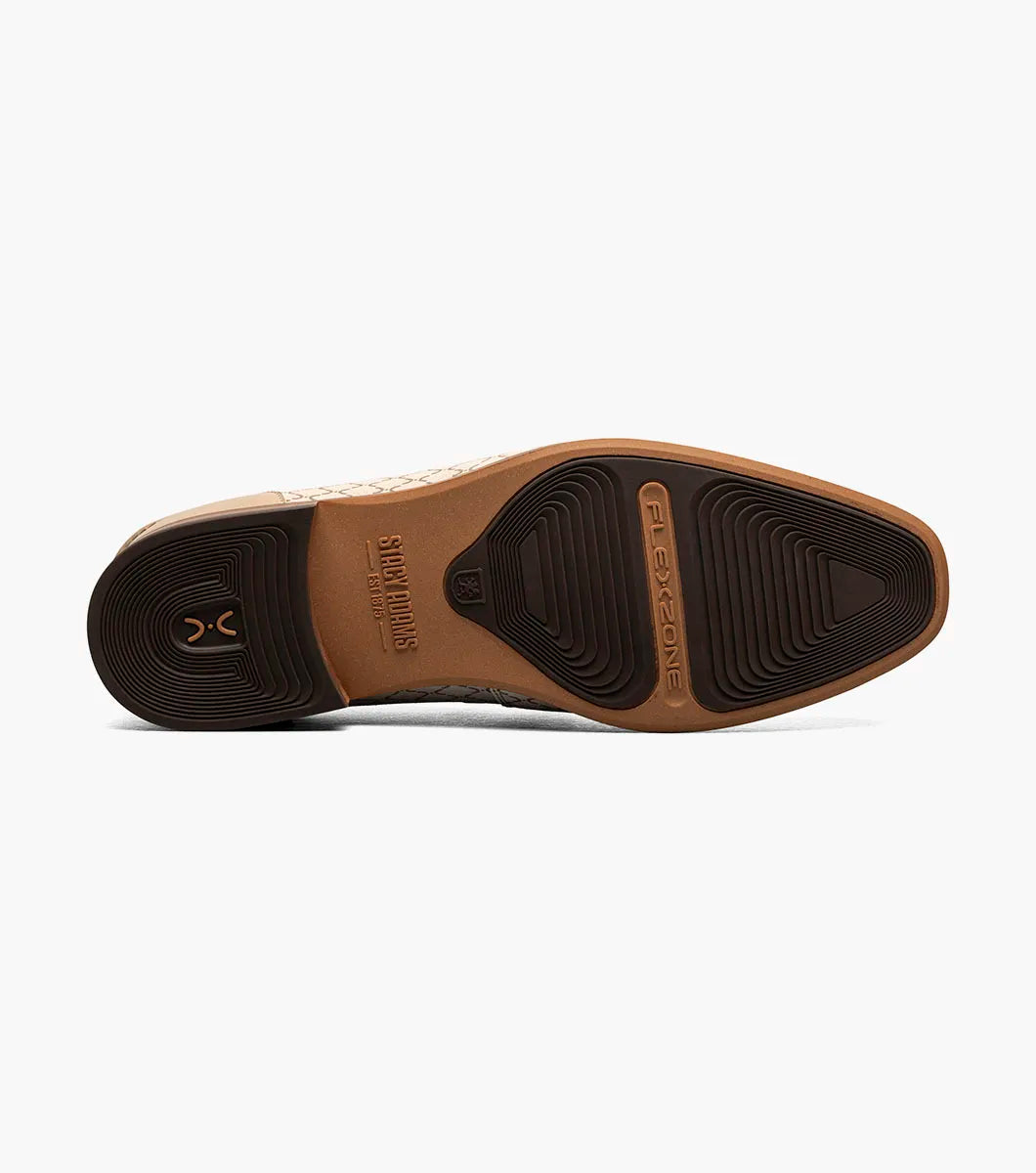 The Stacy Adams Brinkley Moc Toe Bit Slip On in beige features a geometric pattern, leather trim, gold bit detail, wooden heel, and a FlexZone footbed for all-day comfort.