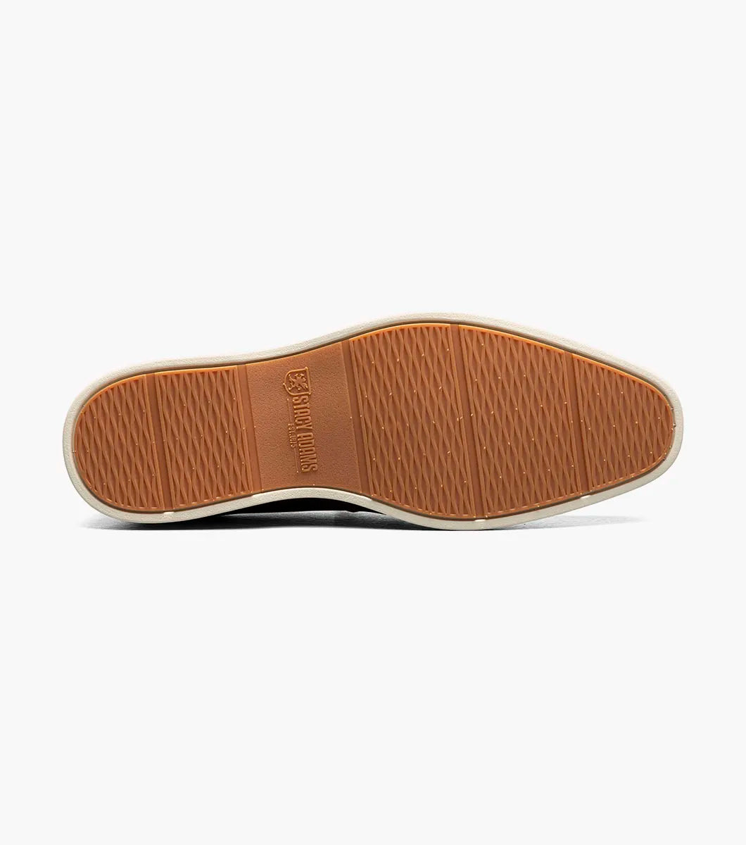 The Stacy Adams Spencer Moc Toe Penny Slip On in black features a leather upper, penny strap, tan lining, and contrasting white rubber sole, showcased on a plain background. Brand: STACY ADAMS. Product code: 25673-001.