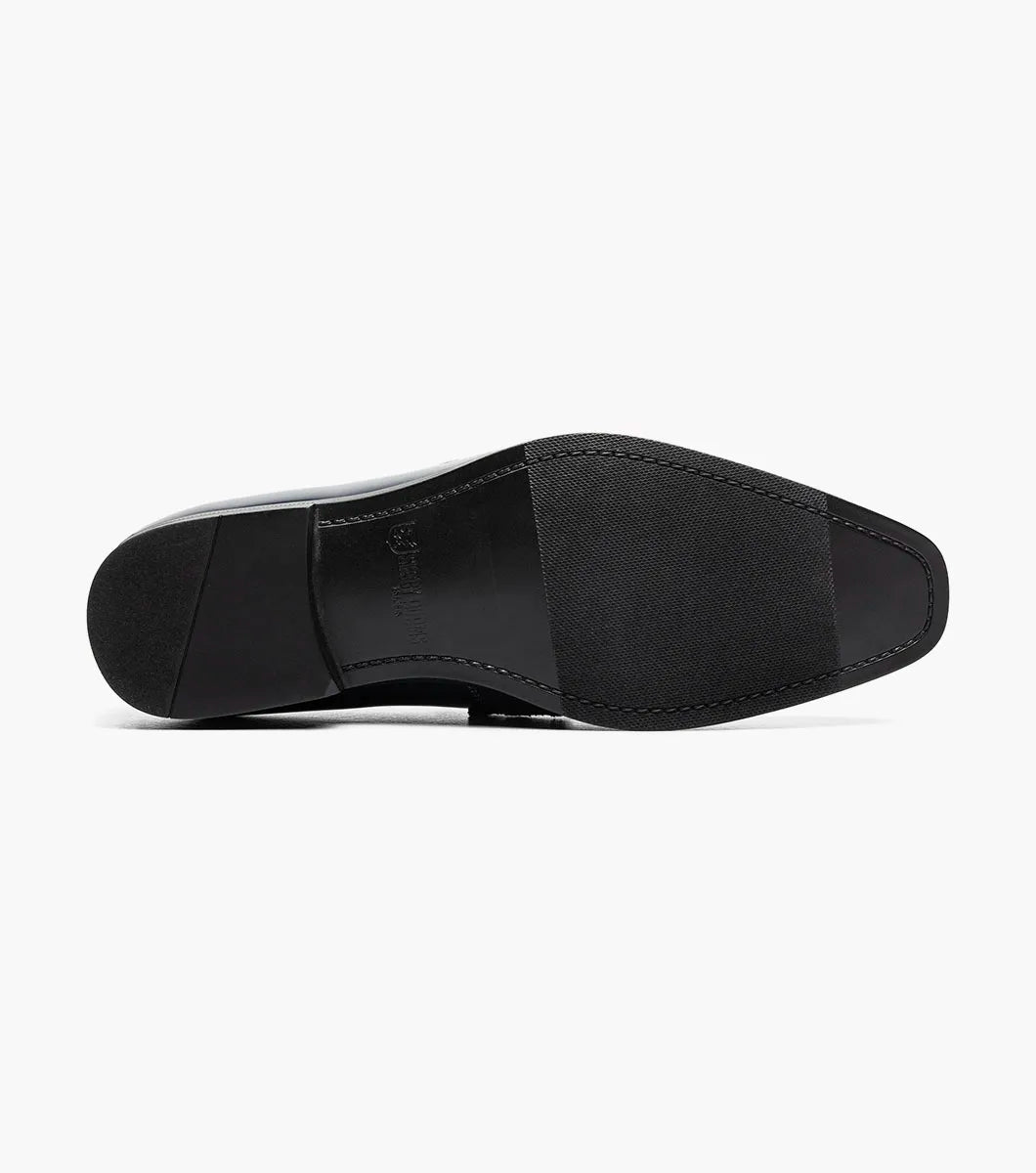 The Stacy Adams Spratley Moc Toe Saddle Slip On (25686-410) features shiny navy blue leather, a matching velour upper, cushioned insole, and low black heel. Displayed solo on a white background.