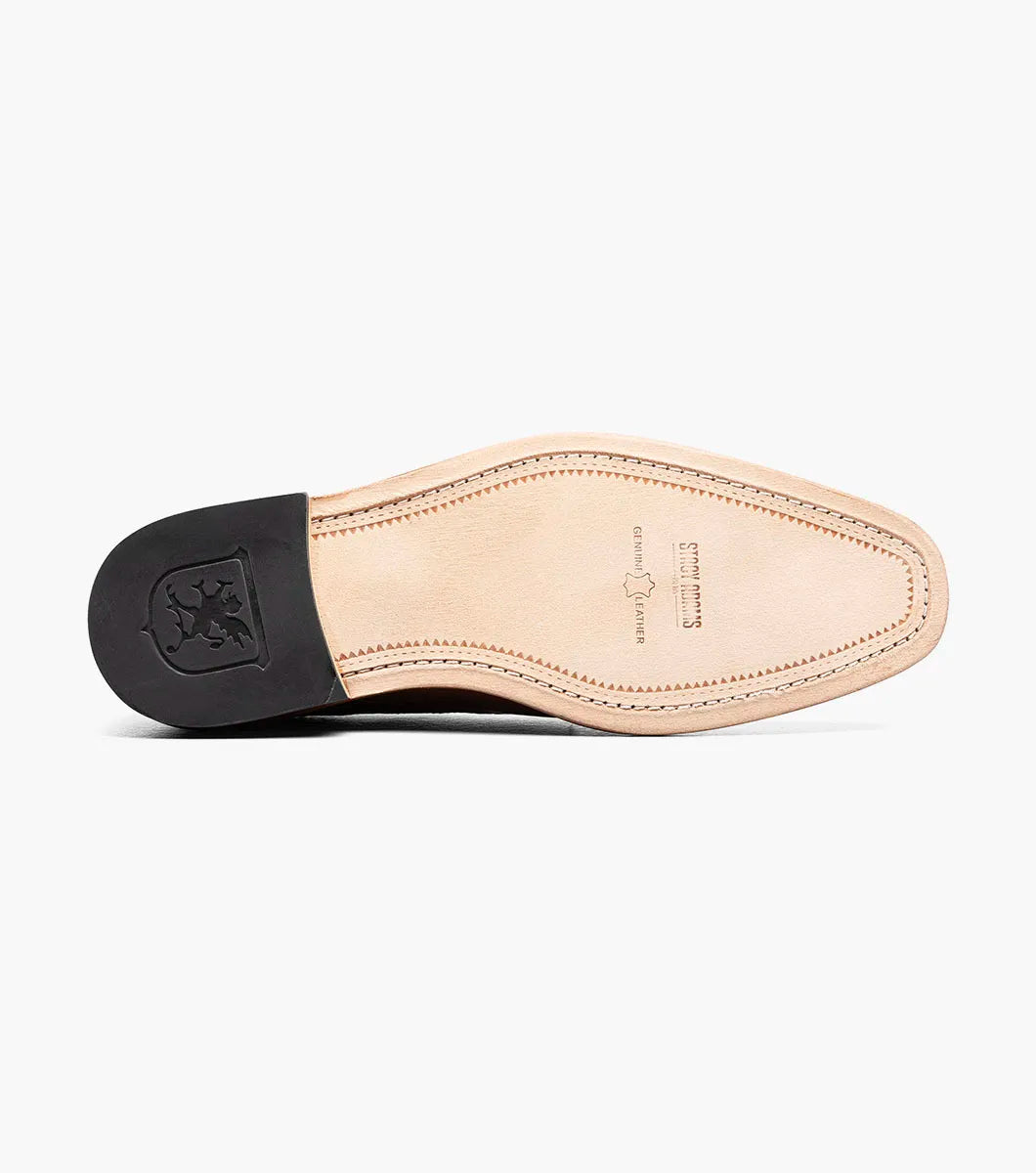 The Stacy Adams Giorgetti Plain Toe Oxford in Cognac features lizard print leather, brogue details, textured accents, a cushioned footbed, low heel, and lace-up closure.