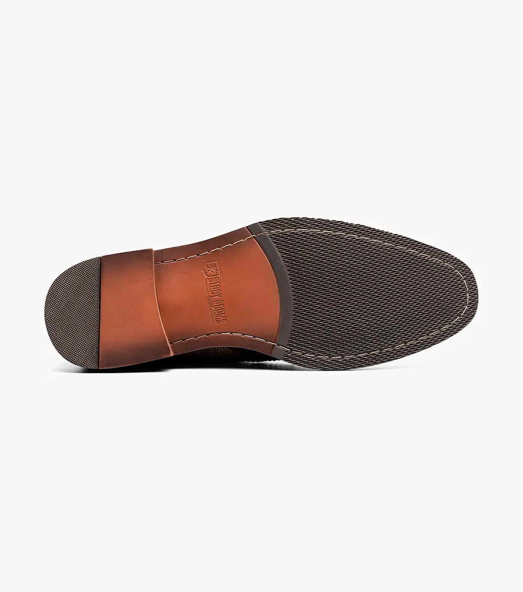 The Stacy Adams Finnegan Wingtip Lace Up Boot in Brown Tumbled (style 25427-247) features brown and tan leather suede, brogue wingtip detailing, a lace-up closure, a memory foam insole for added comfort, and a low heel, shown against a white background.