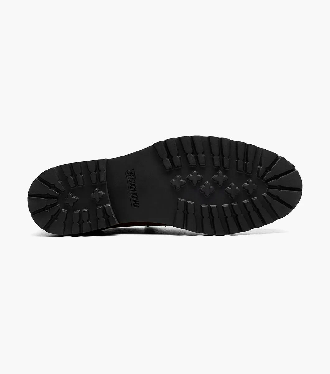 The Stacy Adams Hayes Moc Toe Penny Slip On in tan features anatomical arch support and a black EVA sole, shown here as a single brown leather loafer on a white background.