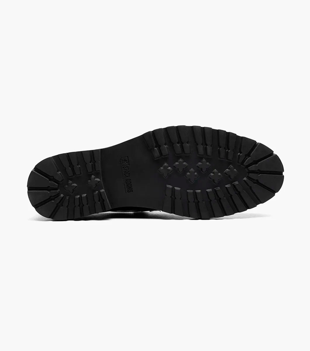 The Stacy Adams Hazelton Moc Toe Penny Slip On (25736-004) in black patent leather features a low heel, thick rubber sole, and RedZone footbed, shown on a white background.