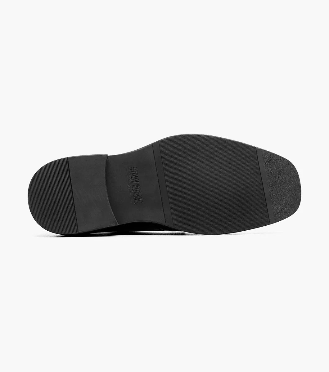 The STACY ADAMS Evan Moc Toe Oxford (Black, 25789-001) is shown as a single men’s dress shoe with a black leather upper, lace-up closure, low heel, and smooth polished finish on a plain white background. Designed for both style and comfort, it features a supportive Memory Foam footbed.
