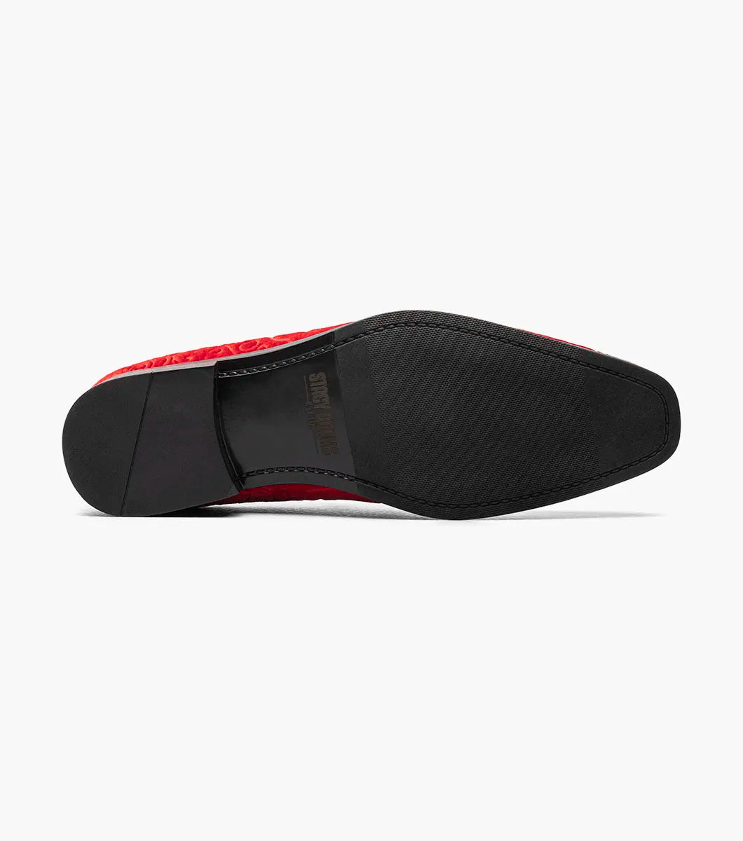 The Stacy Adams Saunders Debossed Velour Slip On in red (25581-600) features swirling embossed patterns, a black sole, and a cushioned insole for comfort.
