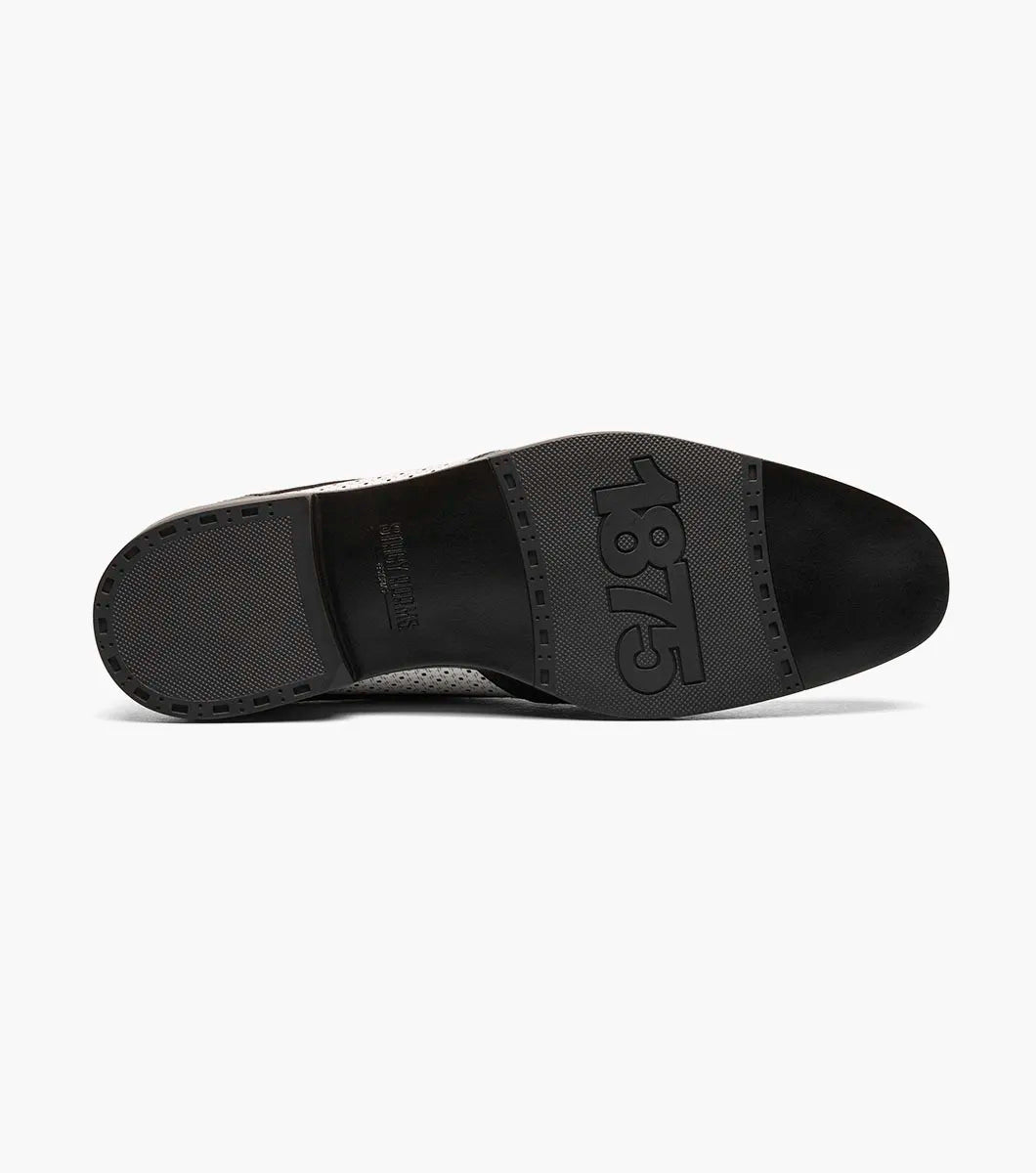 The Stacy Adams Asher Wingtip Lace Up (25653-111) by STACY ADAMS features a black and white leather upper with perforated detailing, lace-up closure, and a low heel, shown on a white background.