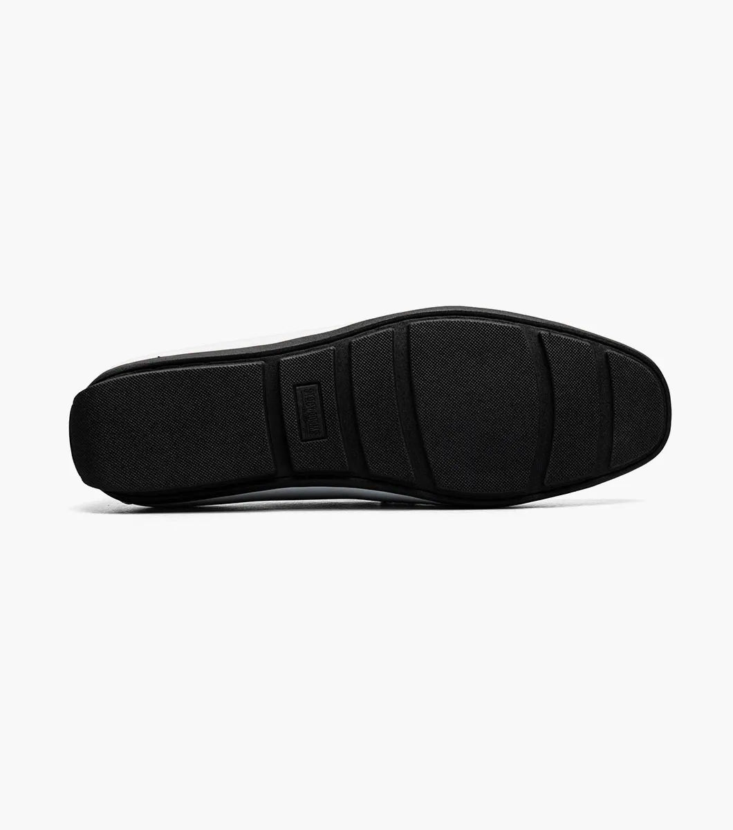 The STACY ADAMS Sheridan Moc Toe Bit Slip On (25761-122) is a white patent loafer with metal bit detail, a black sole, and visible stitching, shown on a plain white background.