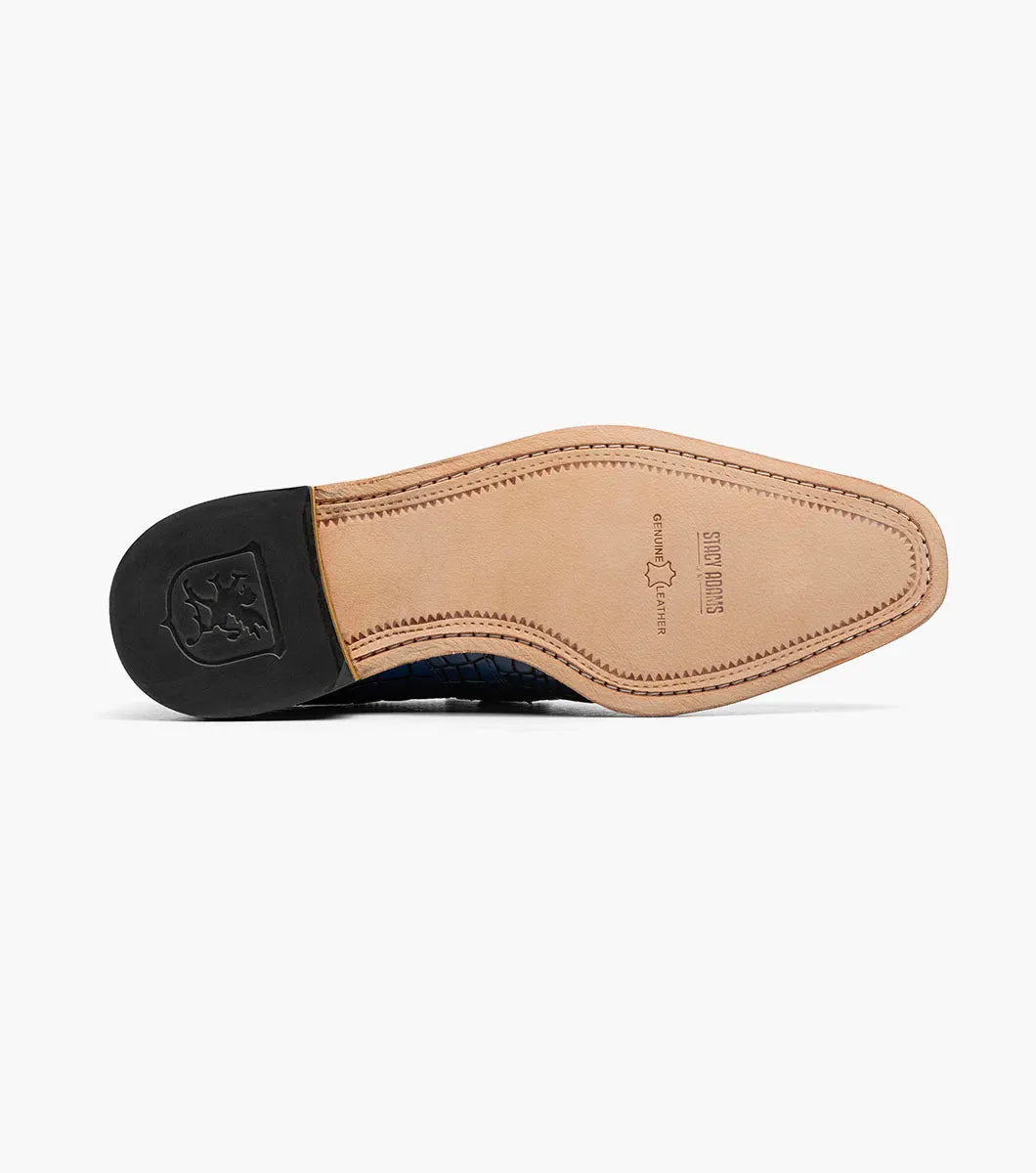 Introducing the STACY ADAMS Rubiano Moc Toe Buckle Strap Slip On in Dark Blue Multi (Style 25787-469)—a men’s loafer featuring a striking blue crocodile print leather overlay, a gray patterned upper, a moc toe slip-on design, side buckle strap detail, and a brown sole.