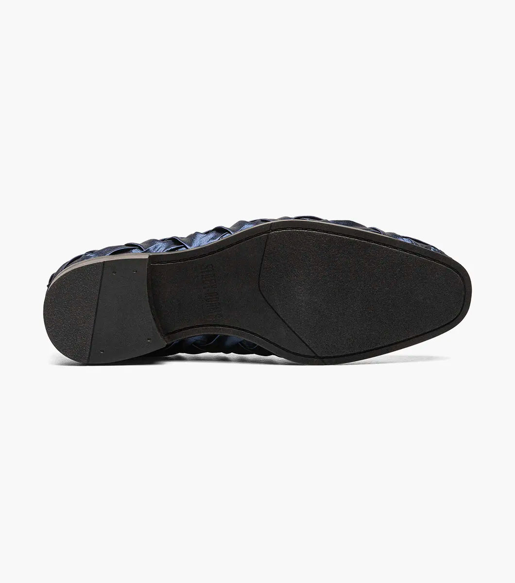 The STACY ADAMS Savoir Plain Toe Satin Slip On (Navy, 25611-410) is a men's loafer with a glossy woven satin design, low black heel, and memory foam insole, shown on a white background.