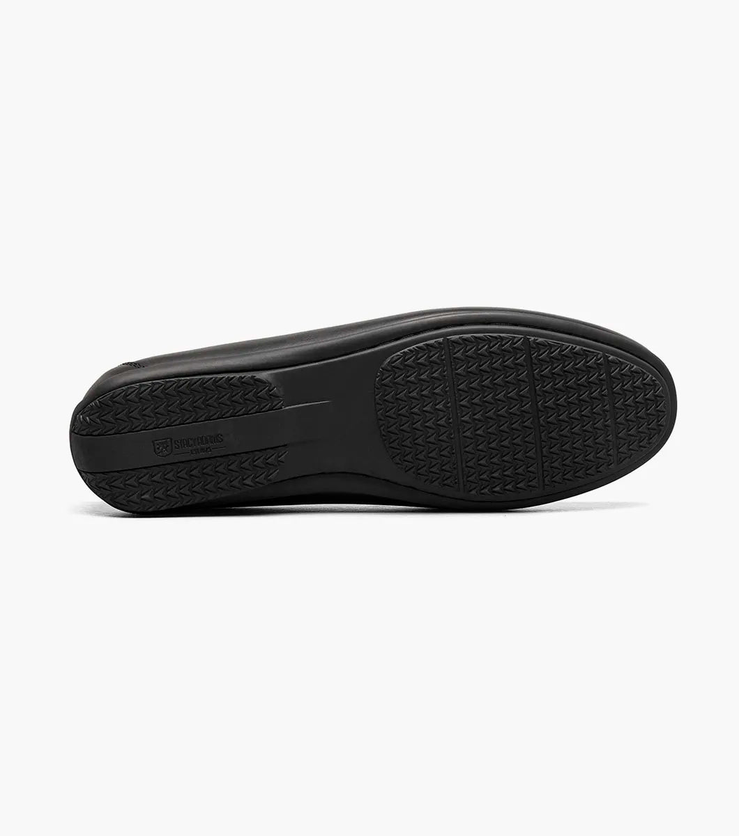 The Stacy Adams Conroy Moc Toe Perf Slip On (Black, 25702-001) features a perforated leather upper, visible stitching, low heel, striped inner lining, and cushioned footbed.