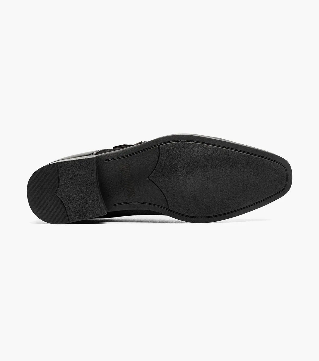 The STACY ADAMS Sutherland Cap Toe Monk Strap in black (style 25793-001) is a formal leather dress shoe with a glossy cap toe, single side buckle, and low heel, shown against a plain white background. These monk strap shoes are designed for all-day comfort with a memory foam insole.