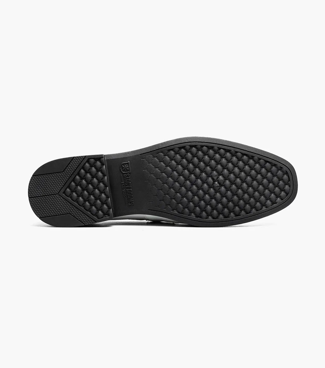 Step up your style with the STACY ADAMS Richmont Moc Toe Bit Slip On in White Tumbled (21567-117), featuring a sleek silver bit, black sole, and tan lining—classic leather loafers perfect for any dress occasion. Displayed on a white background.