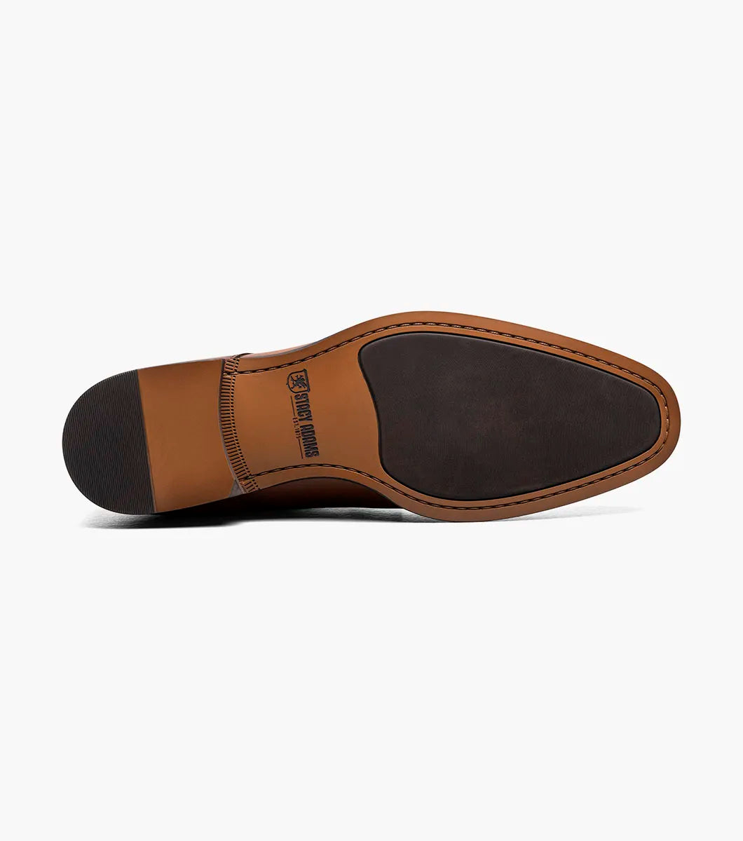 The STACY ADAMS Kaius Plain Toe Double Monk Strap Boot in Cognac (25733-221) features hand-burnished leather, a textured side panel, low stacked heel, and anatomical arch support, shown on a white background.