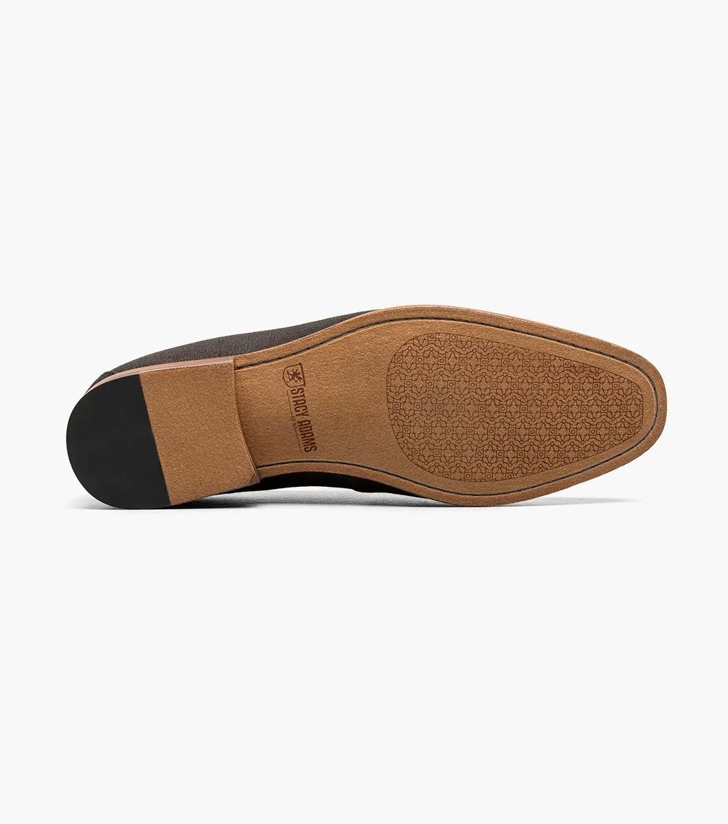 The STACY ADAMS Gill Moc Toe Saddle Slip On (25651-009) is a black multi men’s loafer with a leather upper accent, low heel, RedZone footbed, and rounded toe, shown on a white background.