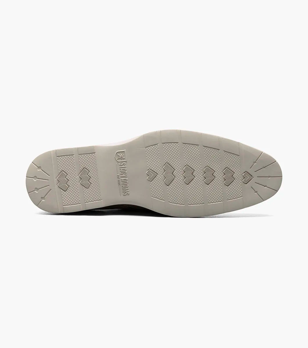 The Stacy Adams Taylen Plain Toe Monk Strap in Sandstone features beige suede leather, a single side buckle, anatomical arch support, low heel, and a textured rubber sole. Displayed on a white background.